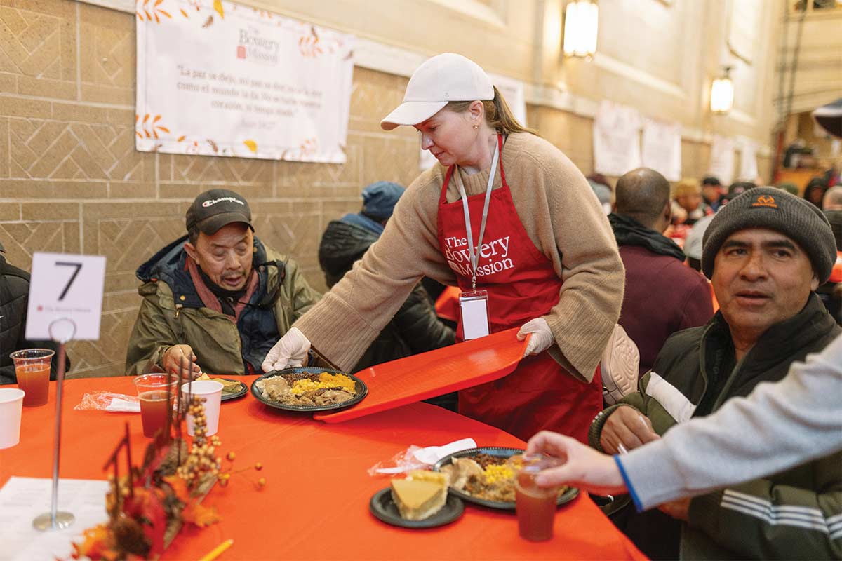 Guests receiving a Thanksgiving meal