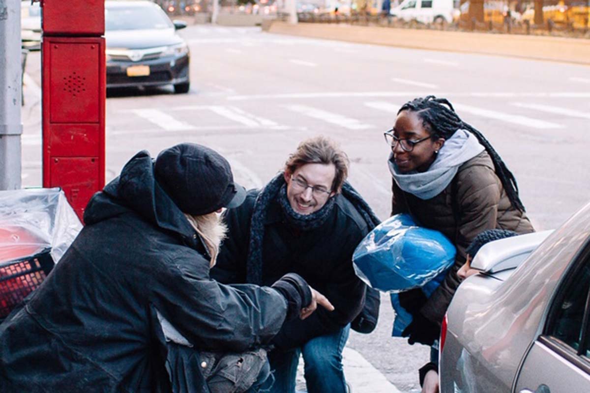 Volunteers speaking with NYC neighbor